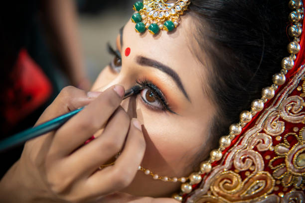 Professional bridal makeup showcasing rosy cheeks and defined eye makeup applied with precision brush on model face
